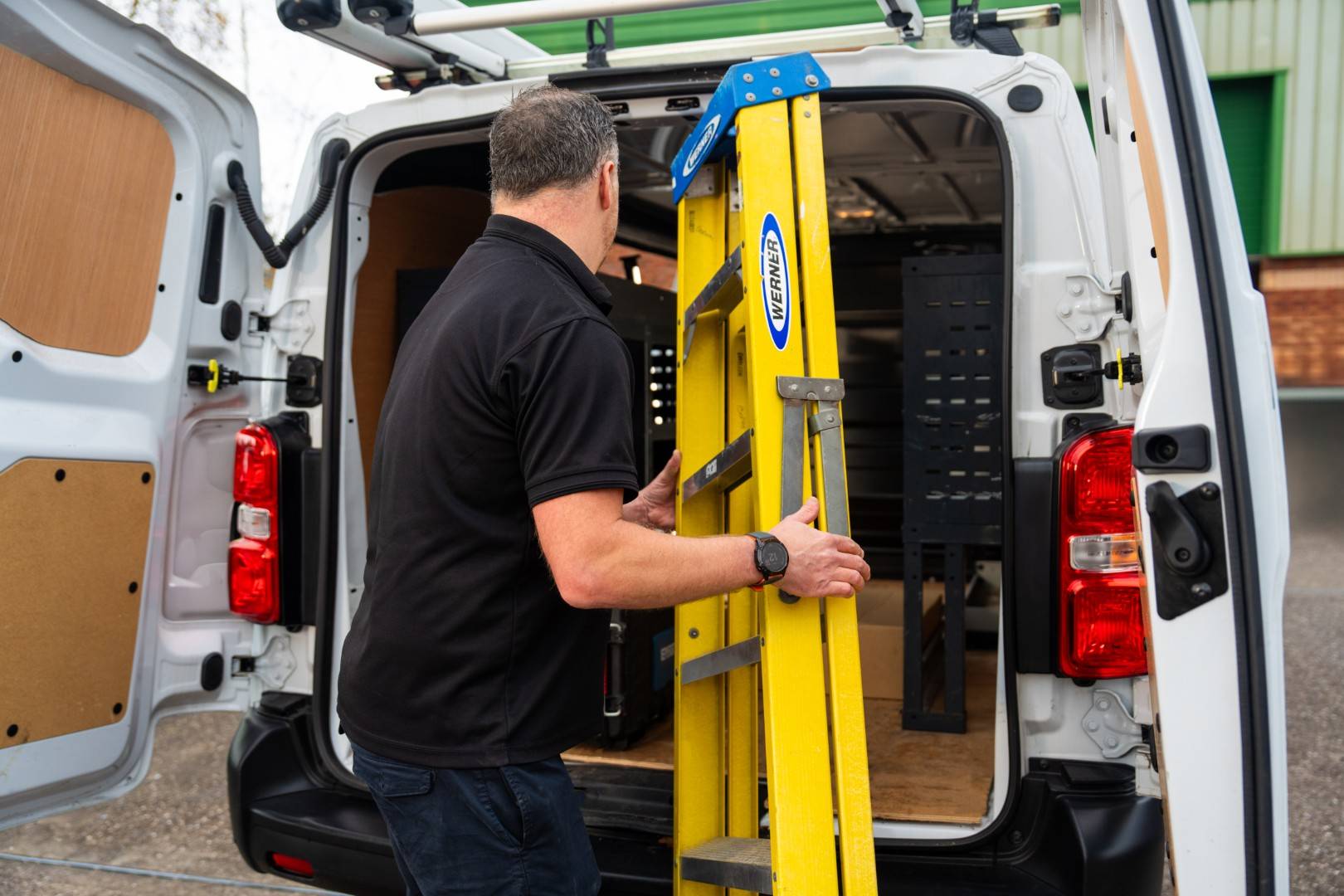 Engineer carrying equipment to van